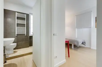 a bathroom with a toilet and a sink and a bed at Lovely 3 rooms apartment close Trastevere Station in Rome