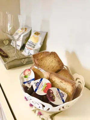 a basket filled with bread and butter on a counter at Casa della Salita San Pietro in Rome