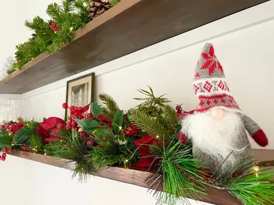 a shelf with a santa clause on it with christmas decorations at Casa della Salita San Pietro in Rome