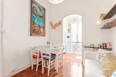 a living room with a table and a white couch at Casa della Salita San Pietro in Rome