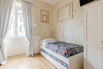 a small bedroom with a bed and a window at Deluxe rooms and One Chilling jacuzzi Suite Guesthouse in Rome