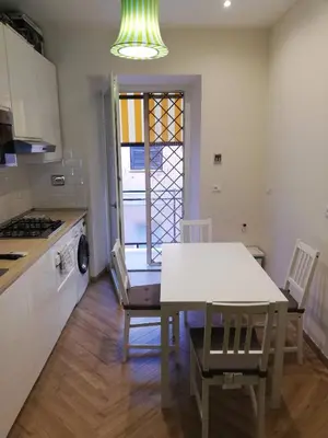 a kitchen and dining room with a table and chairs at Roma TouristHome via palestro 56 in Rome