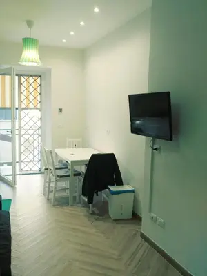 a living room with a table and a flat screen tv at Roma TouristHome via palestro 56 in Rome
