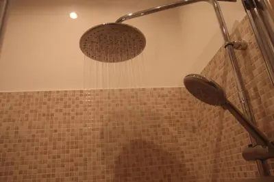 a shower with a shower head in a bathroom at Roma TouristHome via palestro 56 in Rome