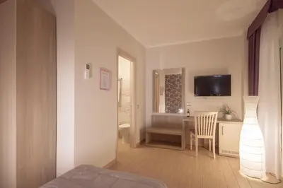 a bedroom with a bed and a desk with a television at Rome Kings Suite in Rome