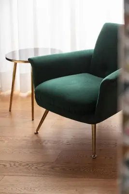 a green chair and a table in a room at Hotel Oceania in Rome
