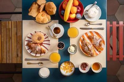 a table topped with plates of breakfast foods and drinks at Hotel Oceania in Rome