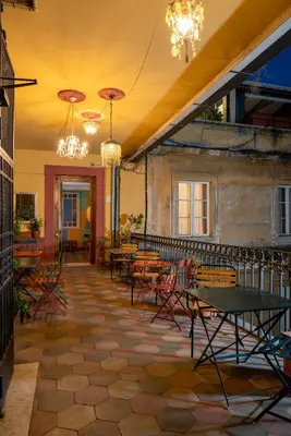 a patio with tables and chairs and chandeliers at Hotel Oceania in Rome
