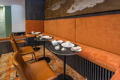 a dining room with two tables and chairs at Fauno Urban Resort in Rome