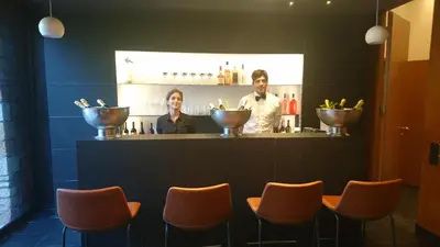a man and a woman standing at a bar at Fauno Urban Resort in Rome