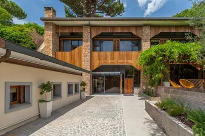 a brick house with a walkway in front of it at Fauno Urban Resort in Rome