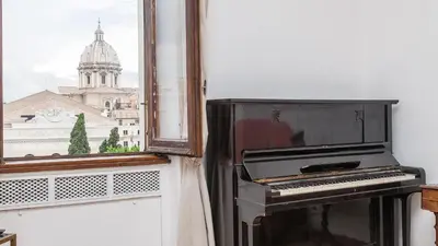an old piano sitting next to a window at Rental In Rome Ancient View in Rome