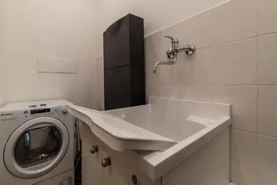 a bathroom with a washing machine and a sink at GuestHost - Sallustiano Apartments in Rome