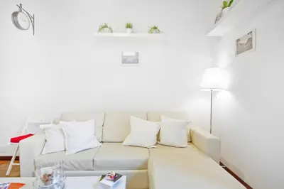 a white living room with a white couch at Arenula Luxury Apartment in Rome