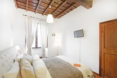 a bedroom with a large bed and a window at Arenula Luxury Apartment in Rome