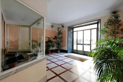 a bathroom with plants and a large window at Domus Ponte Milvio in Rome