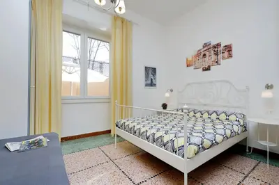 a bedroom with a white bed and a window at Domus Ponte Milvio in Rome