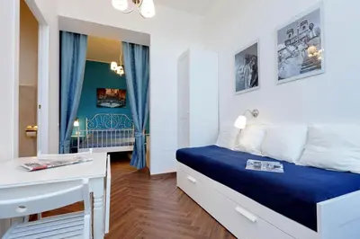 a small bedroom with a bed and a desk at Domus Ponte Milvio in Rome