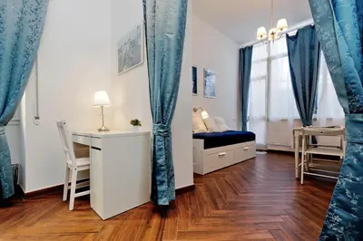 a small room with a bed and a desk and a window at Domus Ponte Milvio in Rome