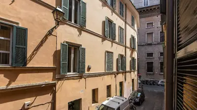 a view of a building with green shutters on it at Rental in Rome Beato Angelico in Rome