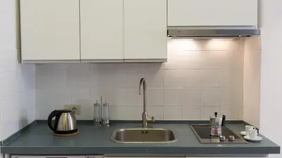a kitchen with a sink and white cabinets at Rental in Rome Beato Angelico in Rome