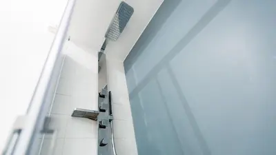 a room with a white tiled wall with benches at Rental in Rome Beato Angelico in Rome