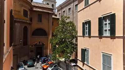 an alley in a city with parked cars and buildings at Rental in Rome Beato Angelico in Rome