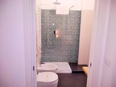 a bathroom with a sink and a toilet and a shower at Casa Italiano - BestBnB Garbatella in Rome