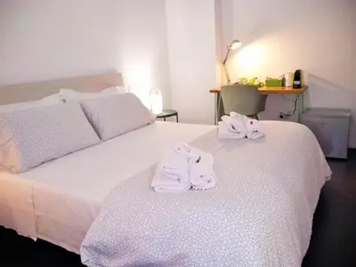 a bedroom with a bed with towels on it at Casa Italiano - BestBnB Garbatella in Rome