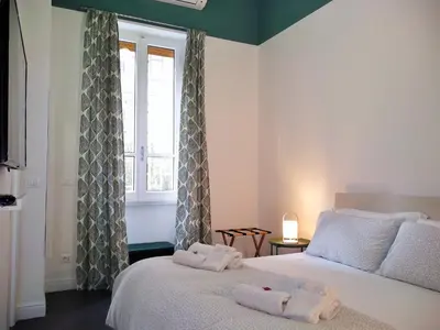 a bedroom with two beds and a window at Casa Italiano - BestBnB Garbatella in Rome