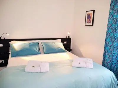 a bedroom with a bed with two towels on it at Casa Italiano - BestBnB Garbatella in Rome