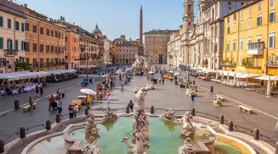 a street with a fountain in the middle of a city at Casa Italiano - BestBnB Garbatella in Rome