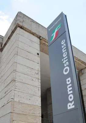 a sign in front of a building at Casa Italiano - BestBnB Garbatella in Rome