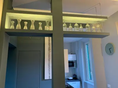 a shelf with bottles on it in a kitchen at La Casetta del Flaminio a Roma Centro in Rome