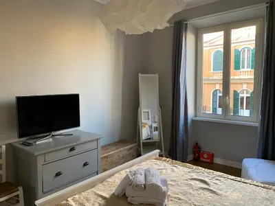a bedroom with a bed and a tv and a dresser at La Casetta del Flaminio a Roma Centro in Rome
