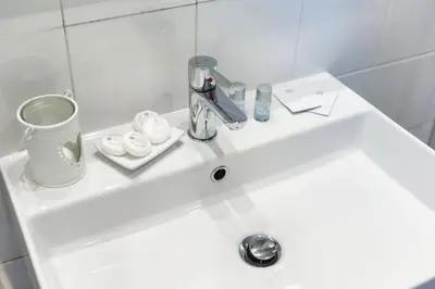 a white bathroom sink with a faucet on it at Cozy studio Campo de Fiori in Rome