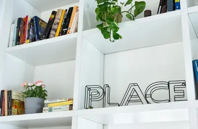 a white book shelf with a potted plant on it at Cozy studio Campo de Fiori in Rome