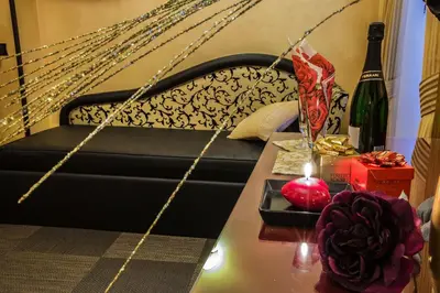 a black couch with a candle on a table at Hotel Romano in Rome