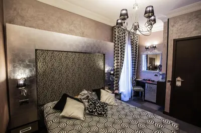 a bedroom with a bed with pillows on it at Hotel Romano in Rome