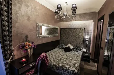 a bedroom with a bed and a mirror at Hotel Romano in Rome