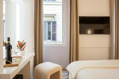 a hotel room with a bed and a window at Pantheon Suites Rome 2 in Rome