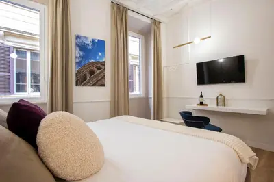 a hotel room with a bed and a tv at Pantheon Suites Rome 2 in Rome