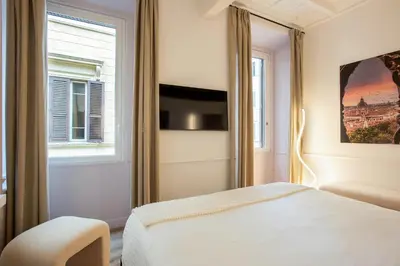 a bedroom with a bed and a window at Pantheon Suites Rome 2 in Rome