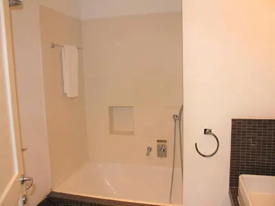 a bathroom with a shower with a bath tub at Relais Fori Imperiali in Rome