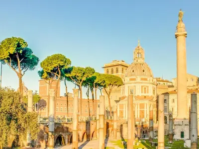 a building with a column and trees in front of it at Relais Fori Imperiali in Rome