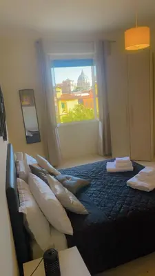 a bedroom with a bed with pillows and a window at Vatican Sofia house in Rome