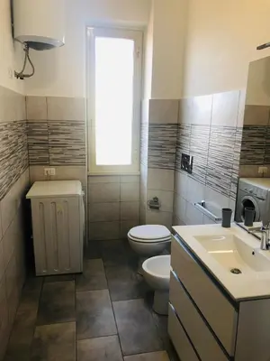 a bathroom with a toilet and a sink and a window at Vatican Sofia house in Rome