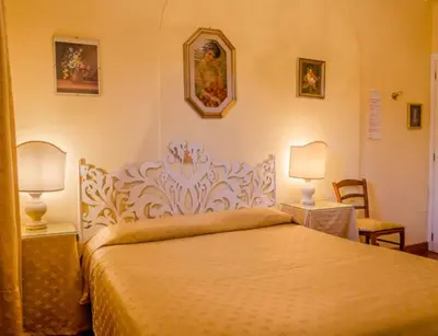a bedroom with a bed and two tables and two lamps at B&B Seneca in Rome