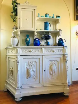a white cabinet with blue vases on top of it at B&B Seneca in Rome