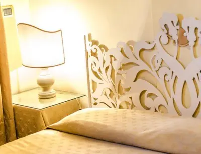 a bedroom with a bed with a lamp on a table at B&B Seneca in Rome